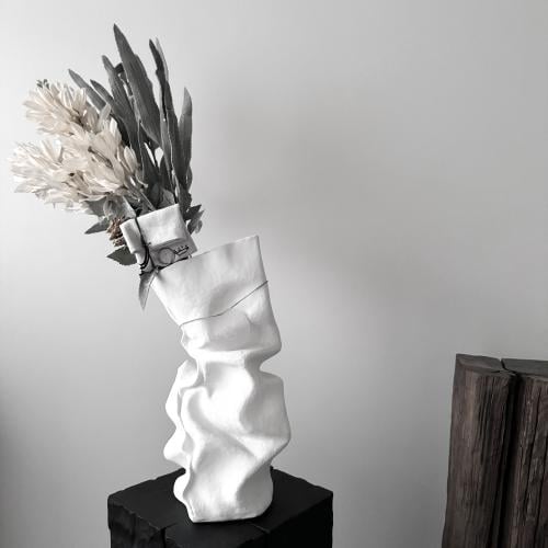 Arrangement of flowers with a fabric envelope