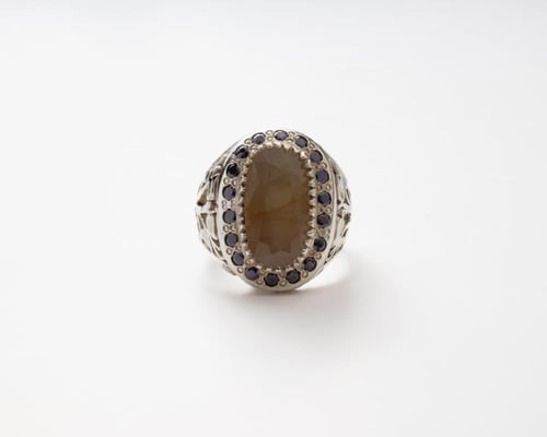 خاتم زبرجد مرصع بالزركون الازرق