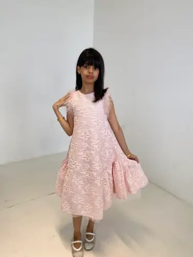 Pink dress with embroidery on the fabric and feathers on the shoulders