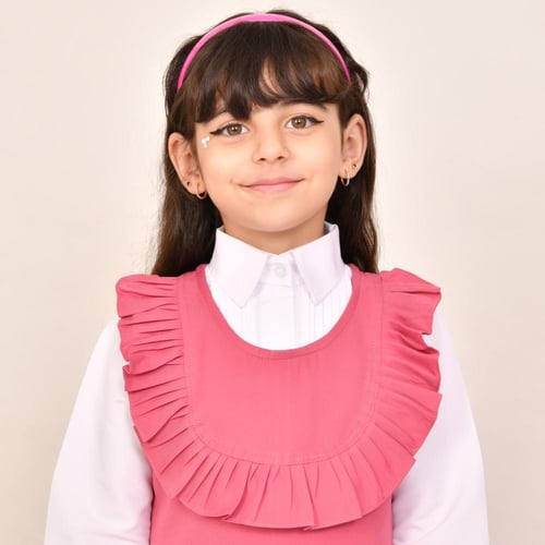 مريول ابتدائي وردي ياقة دائرية وكشكش عريض