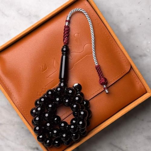 Black beaded rosary with a tassel, detailed