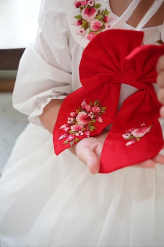 فستان فيونكه بتفاصيل زهور حمراء