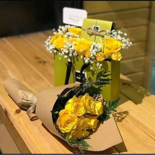 A bouquet of flowers with chocolate box arrangemen...