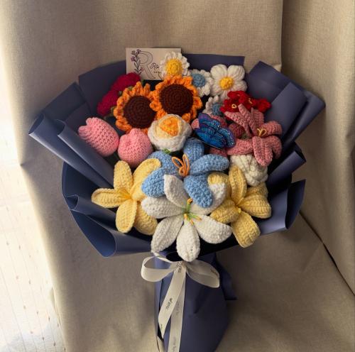 A crochet flower bouquet that includes all types o...
