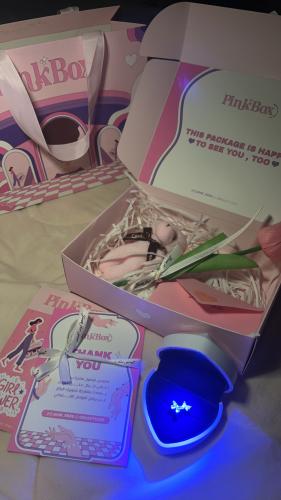 Pink butterfly box ring illuminated with the phrase "Safety is sweet" ring in your hand