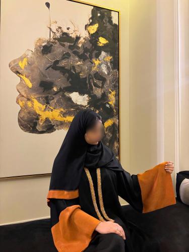 Black A-line abaya with collar and wide orange sle...