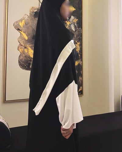 Black A-line abaya with wide white sleeves