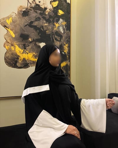 Black A-line abaya with wide white sleeves