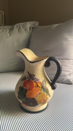 A ceramic vase/pitcher decorated with hand-drawn f...