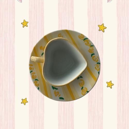 A yellow cup in the shape of a heart, hand-drawn