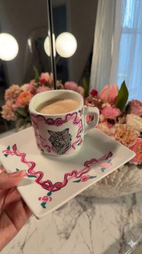 A cup of coffee with a plate