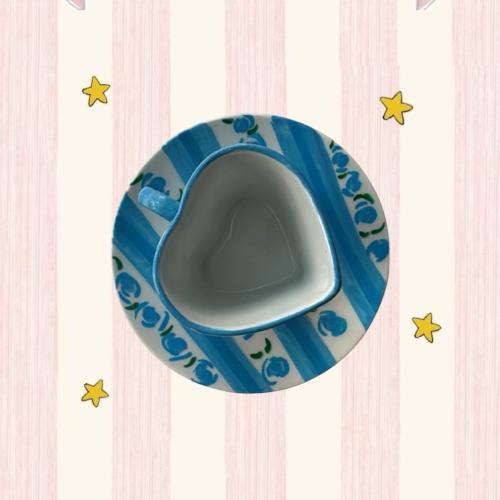 A blue cup in the shape of a heart, hand-painted