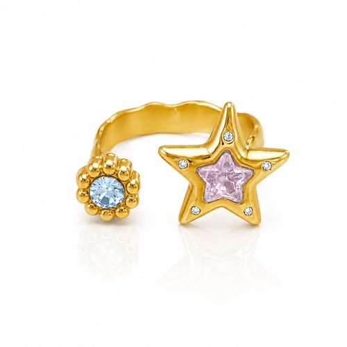 Star and colored crystal ring, gold against rust