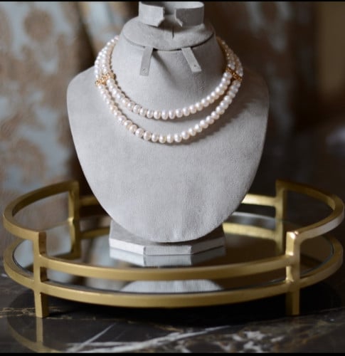 A designer necklace made of two layers of natural farmed pearl with gold-plated spacers 24k