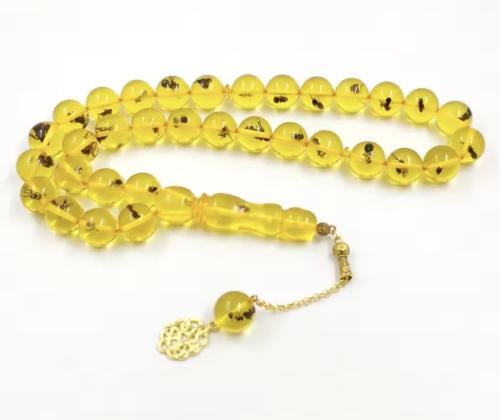The yellow rosary contains a real insect.