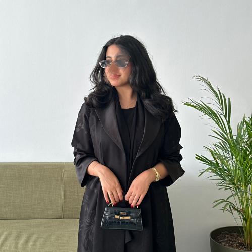 (0004) Black jacquard abaya with black rose patterns, subtly visible in parts of the abaya and matte in other parts, with silk sat...