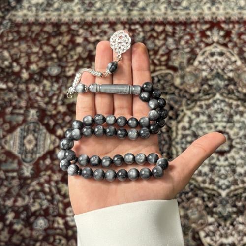 A beaded rosary in gray Calayite with marbling