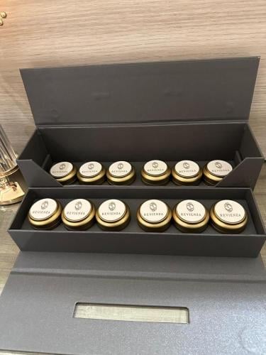 An elegant box containing small metal tins