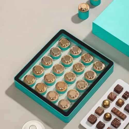 Acrylic box containing luxurious metal tins