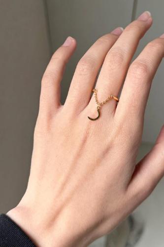 A letter ring, a chain with an elegant and delicat...