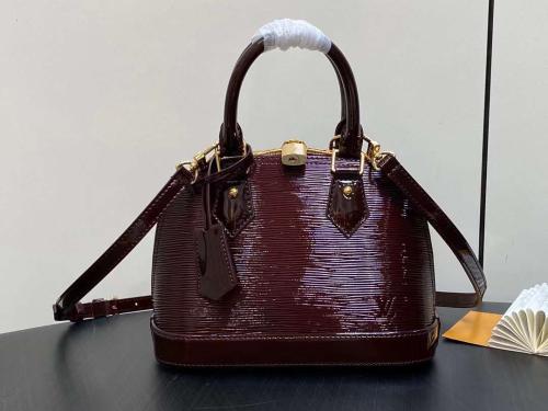 An ambery LV Alma handbag