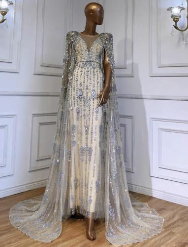 Long embroidered dress with sleeves and cape desig...