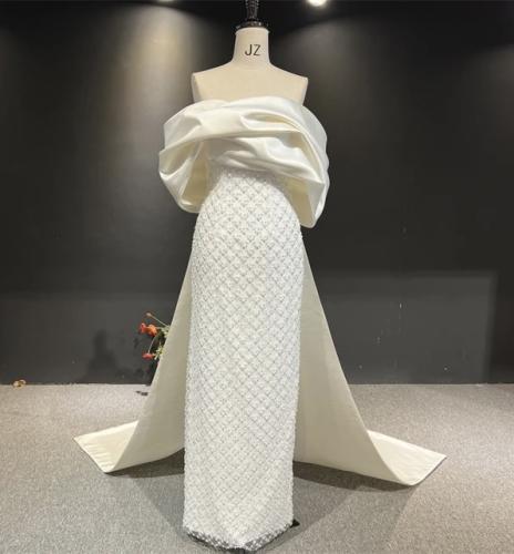 Evening dress white beads with a model on the ches...