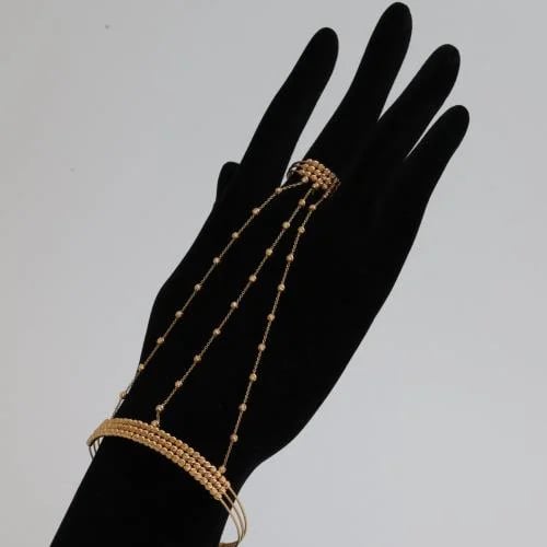 Gold cuff with a traditional design in striking co...