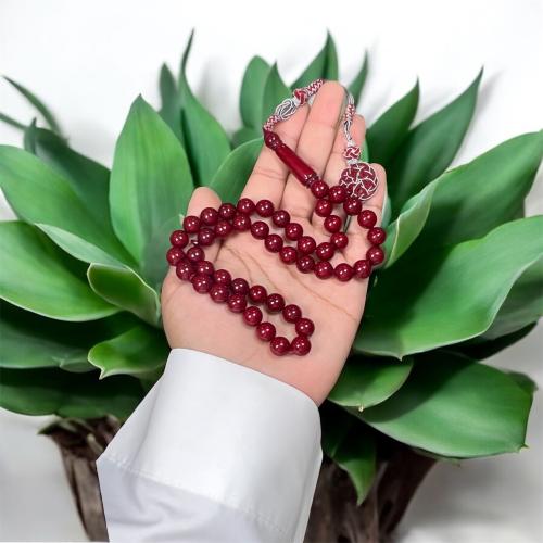 A prayer bead with a brass tassel.