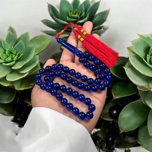 A prayer bead with a clasp, decorated with a Karko...