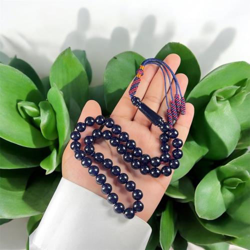 A prayer bead with a clasp, decorated with a Karko...
