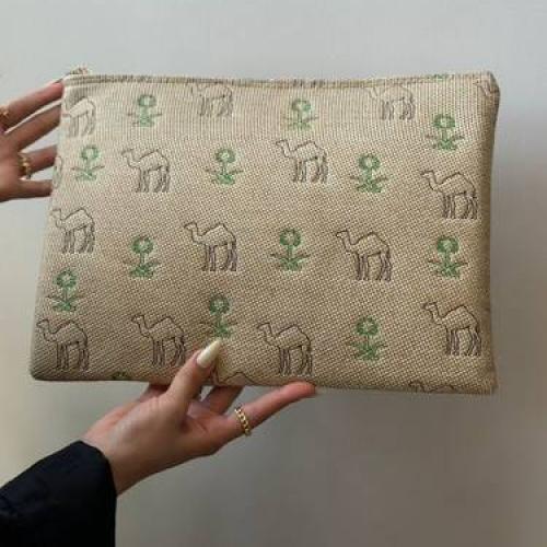 Beauty pouch with two swords and a palm tree