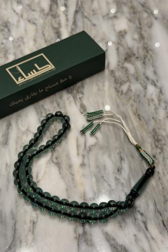 A prayer bead with a turquoise agate pendant