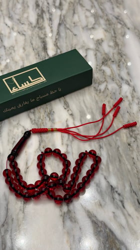 A prayer bead with a turquoise agate pendant
