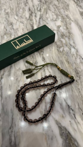A prayer bead with a turquoise agate pendant