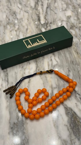 A prayer bead with a turquoise agate pendant