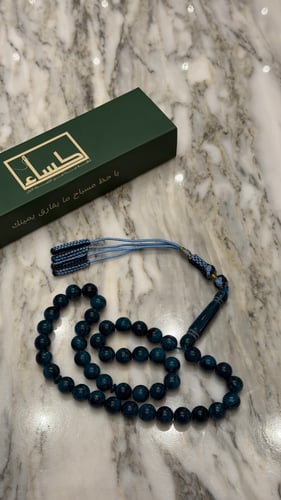 A prayer bead with a turquoise agate pendant