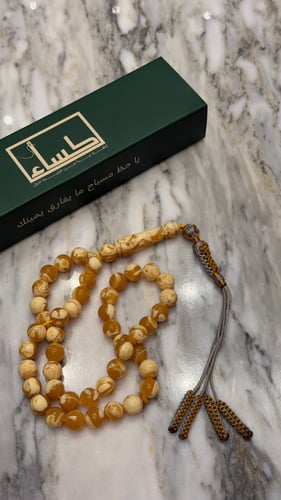 A prayer bead with a turquoise agate pendant