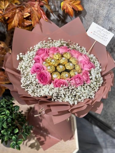 شوكولاته روشيه منسقة وسط بوكيه ورد طبيعي