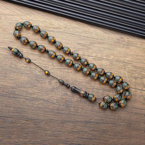 سبحة خرز أسود بنقشات دوائر أصفر وأخضر