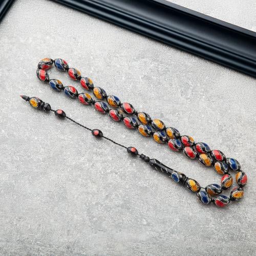 سبحه سوداء بنقشات كحلي واصفر واحمر