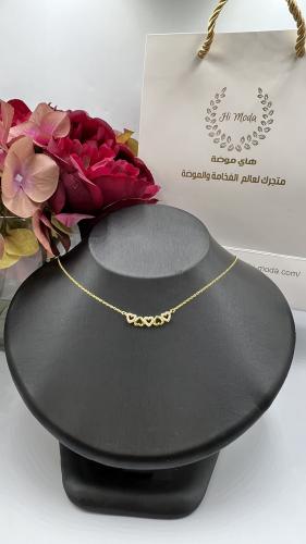 Silver and zircon charm in the shape of golden hearts