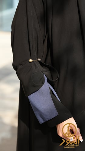 عباية بأزرار أمامية وأكمام أنيقة بتدخيل قماش كحلي