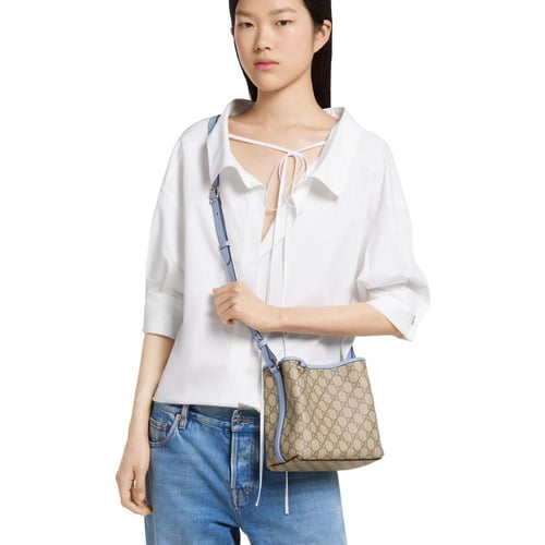 Gucci | GG Emblem small bucket bag | beige and dar...