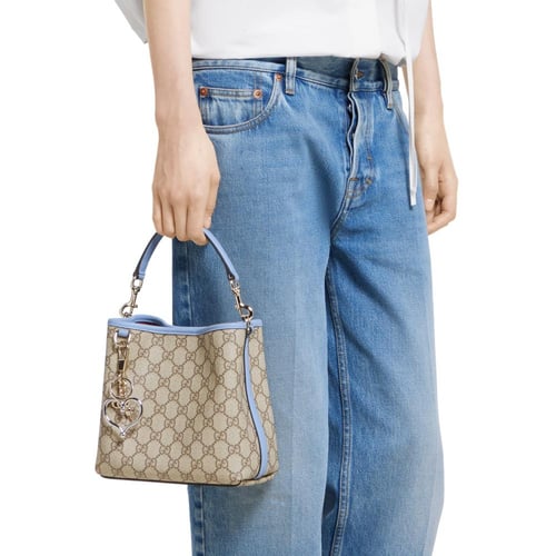 Gucci | GG Emblem small bucket bag | beige and dar...