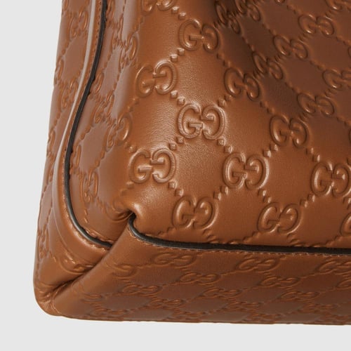 Gucci | GG Emblem small bucket bag | brown GG leat...