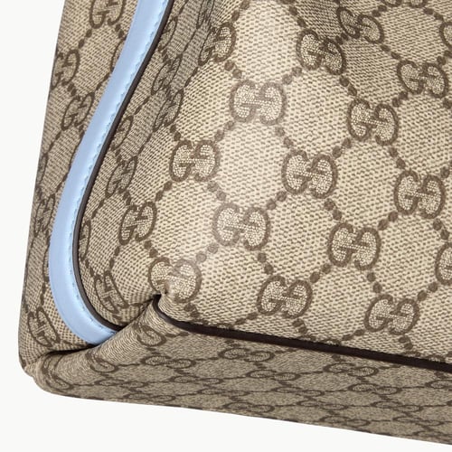 Gucci | GG Emblem small bucket bag | beige and dar...