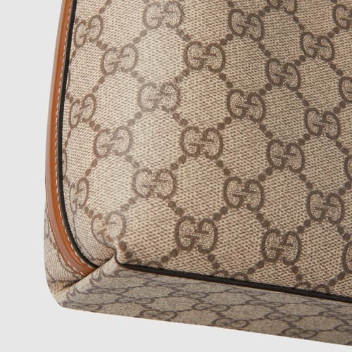 Gucci | GG Emblem nano bucket bag | beige and dark...