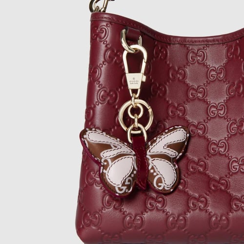 Gucci | GG Emblem small bucket bag | Rosso Ancora...