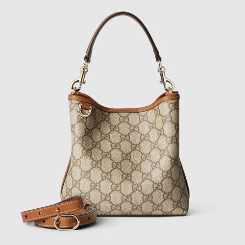 Gucci | GG Emblem small bucket bag | beige and dar...